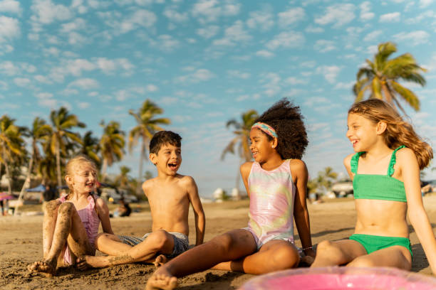 istock Friends children talking on the beach 2122372236