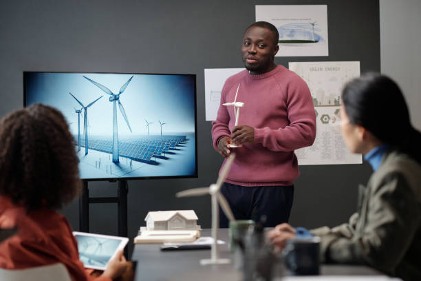 istock Businessman with model of windmill 2122377509