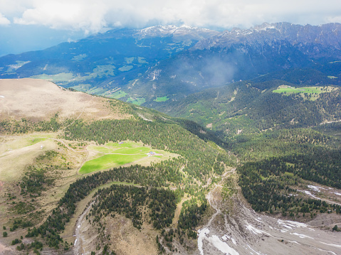 Seceda Mountain peak with green field, Dolomites Alps Aerial shot of Tre Cime Di Lavaredo, Italy