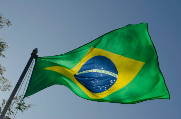 istock Brazil pennant fluttering in the wind with blue sky 2122396566
