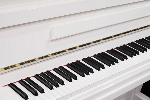 White grand piano with open lid