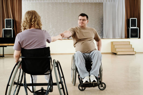 istock Man And Woman In Wheelchairs Dancing 2122431128