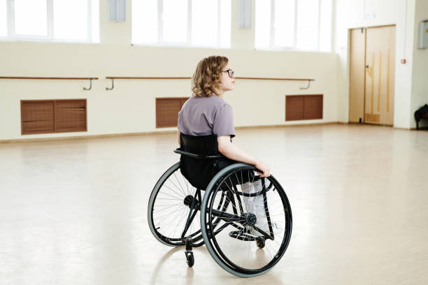 istock Young Woman With Disability Alone In Dance Studio 2122438971
