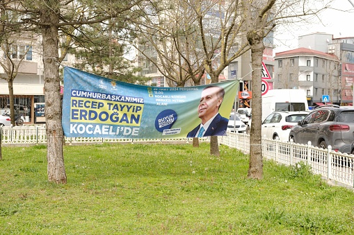 Gebze, Kocaeli - Mach 29 2024: 2024 Turkiye Municipal elections. Mayoral candidates, local elections. Party flags hung on the streets, noisy election cars. Visual and sound pollution in Turkey during election time