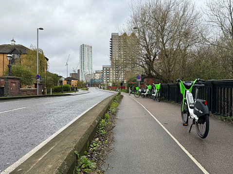 Lime electric hires parked across the pavement in Tottenham Hale in North London. march 2024