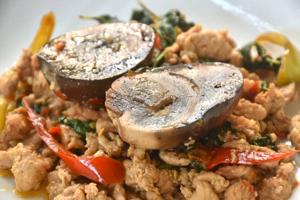 istock slice boiled  black preserved egg dressing spicy fried chop chicken meat and basil leaf 2122468247