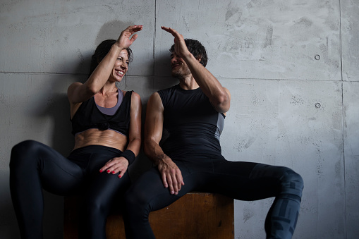 Fit Couple Celebrating Workout Success in Gym