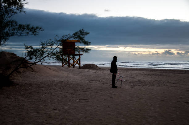 Man photographing the sea at dawn
