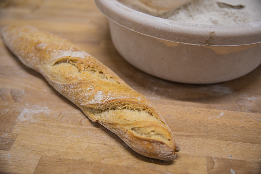 Sourdough bread on wooden shelves. Bakery shelf with golden crusty bread