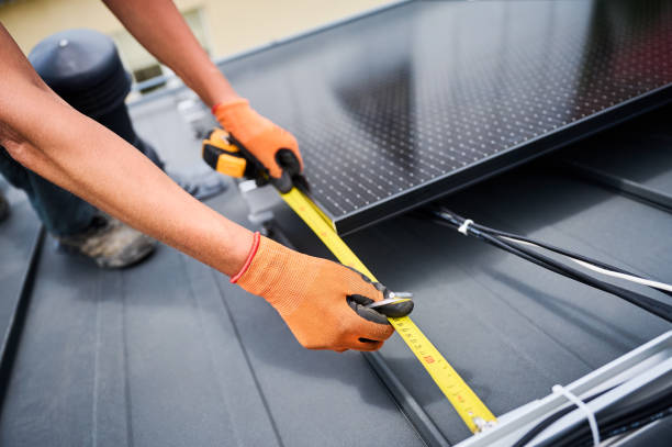istock Worker building photovoltaic solar panel system, using ruler to measure mounting equipment. 2122526684