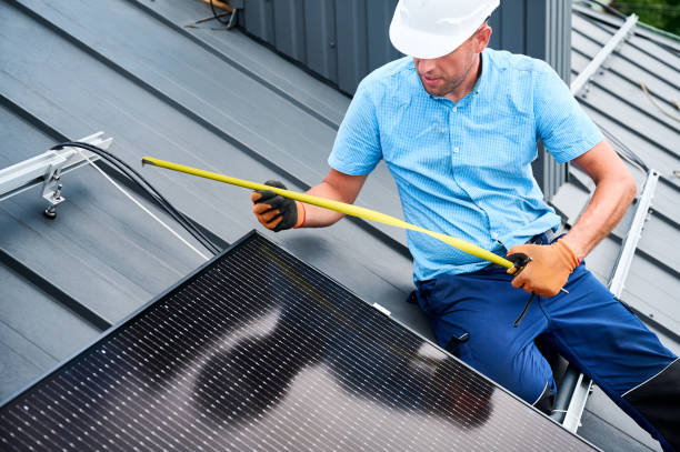 istock Worker building photovoltaic solar panel system, using ruler to measure mounting equipment. 2122526686