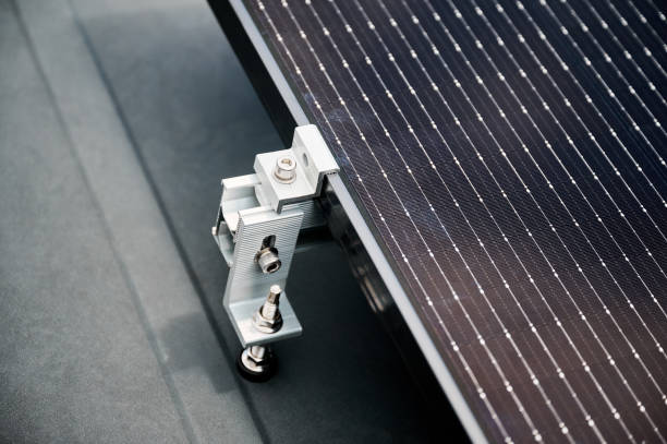 istock Solar panels, securely fastened with mounting clamp to supporting structure on rooftop of house. 2122526688