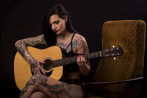 istock Young woman playing a guitar 2122547758