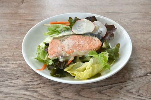 gelled salmon with mixed vegetable salad dressing spicy and sour seafood cream sauce on plate
