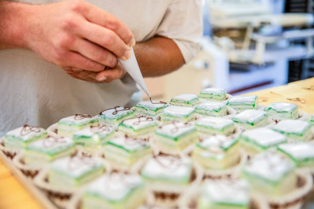 German male baker is decorating vegan petit fours