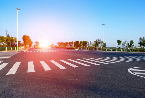 Zebra Crossing and traffic sign background at sunset.
