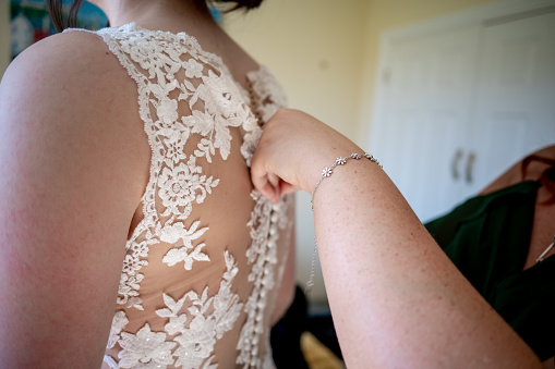 Bride's Dress being Buttoned Up