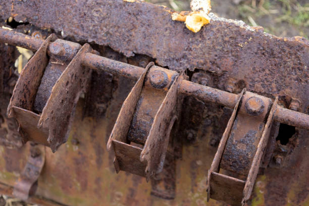 An old, rusted and disassembled seed drill for grain.
