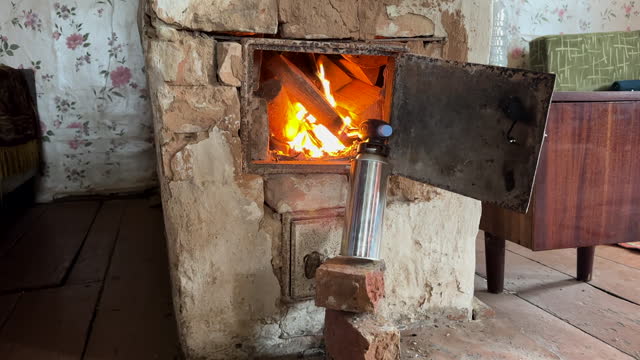Lighting firewood in old stove. Lighting a Fire use gas burner.