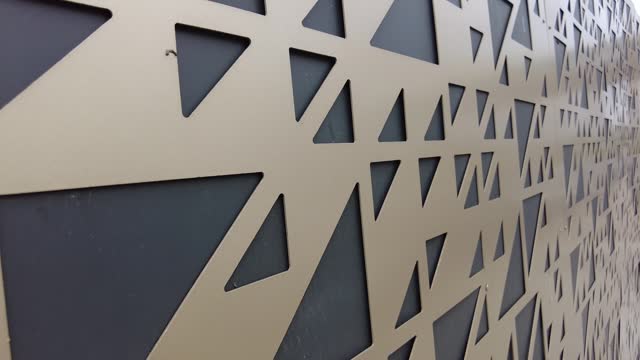 A metal wall with a triangular pattern