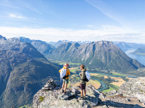 istock Two Hikers With Backpacks Standing On Top Of A Mountain 2122647700