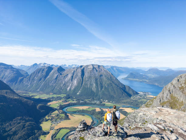 istock Two Hikers Overlooking a Fjord 2122648212
