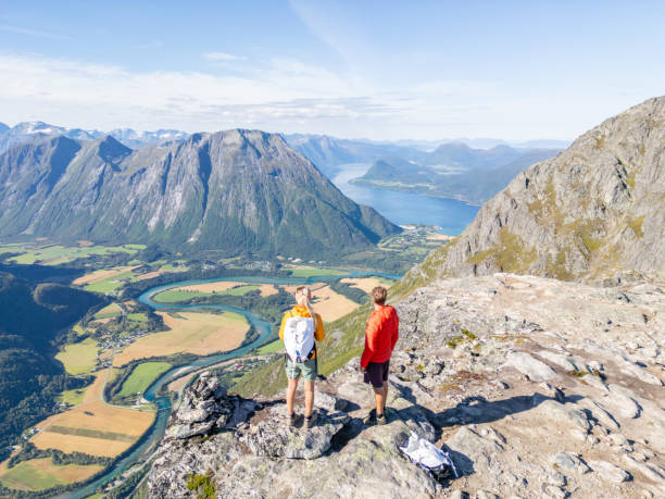 istock Two Hikers Looking At A Fjord From A Mountain Top 2122648769