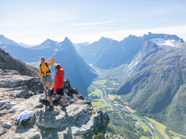 istock Two hikers high-fiving on a mountain 2122648810