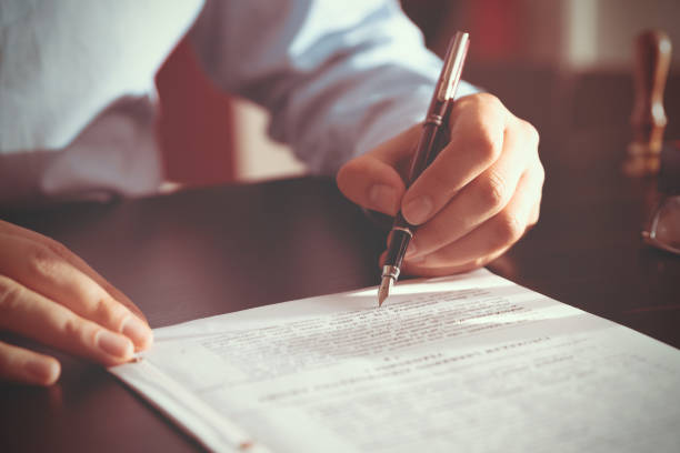 istock Notary public in office signing document 2122663960