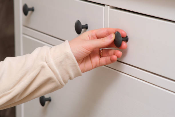 istock A woman's hand opens a drawer, close-up. Cabinet drawer 2122670518