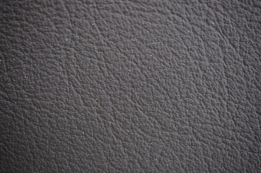 Car seat black natural leather texture extreme close-up