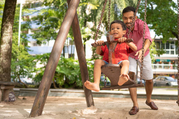 istock Father and son playing in public park 2122735908