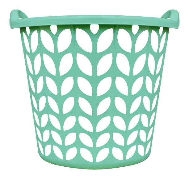 Little boy playing with basket full of clean clothes.