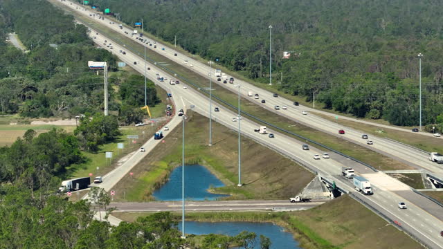Above view of wide highway in Florida with fast driving cars during rush hour. USA transportation infrastructure concept