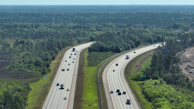 View from above of american wide freeway in Florida with dense traffic of driving cars during rush hour. USA transportation infrastructure concept