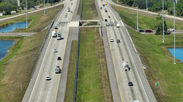 Above view of wide highway in Florida with fast driving cars during rush hour. USA transportation infrastructure concept