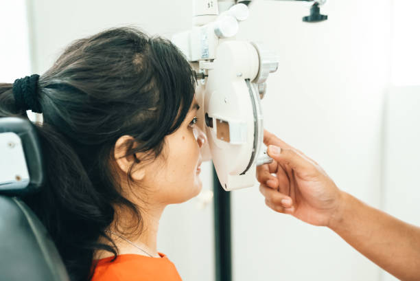 istock asian young woman looking through phoroptor 2122770918