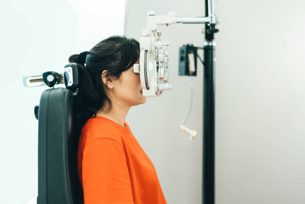 istock asian young woman looking through phoroptor 2122771047