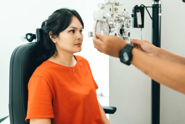 istock asian young woman looking through phoroptor 2122771057