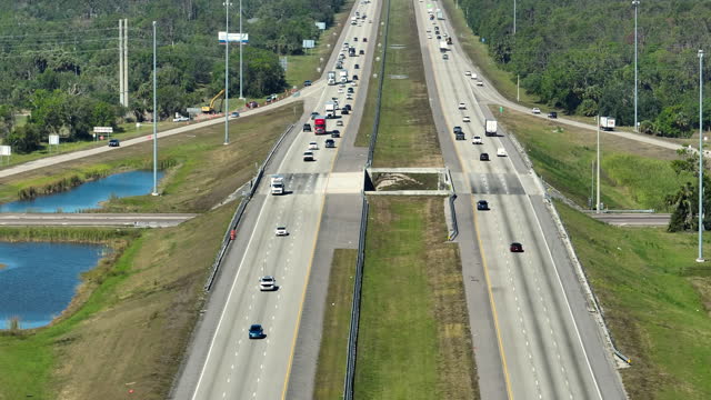 Top view of mulitlane american highway with rapid driving cars during rush hour in Florida. View from above of USA transportation infrastructure