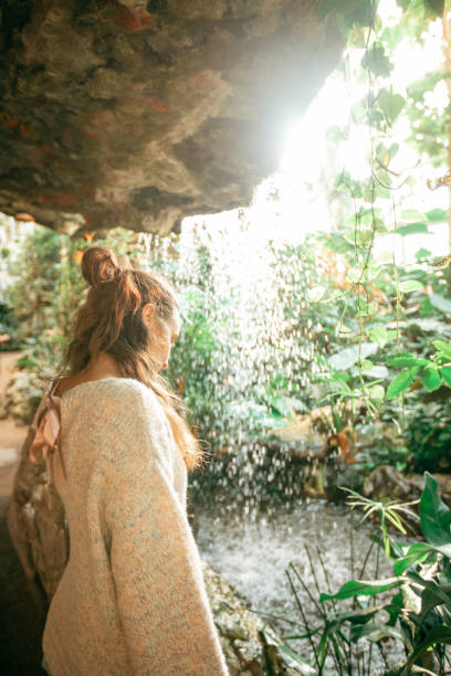 istock Young woman enjoys greenhouse 2122838325