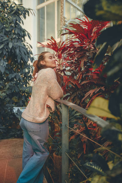 istock Young woman enjoys greenhouse 2122842564
