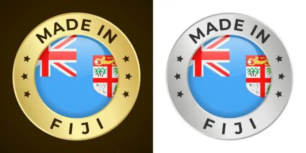 Vector illustration of Made in Fiji - Vector Graphics. Round Golden and Silver Label Badge Emblem Set with Flag of Fiji and Text Made in Fiji. Isolated on White and Dark Backgrounds