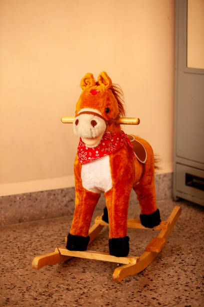 istock A stuffed horse is sitting on a rocking horse 2122902197