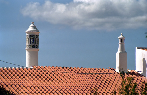 detail of a chimney stack in the town of Lulè against the sky