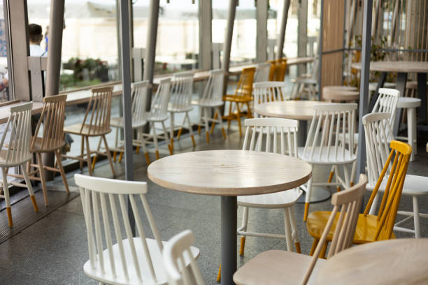istock Interior of a empty restaurant. Empty restaurant tables near windows 2122928931