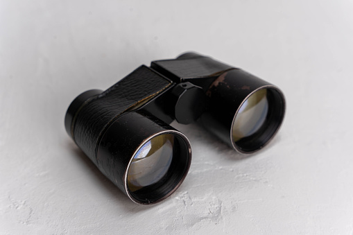 Antique small theatrical binoculars displayed on a clean white background, leaving plenty of space for text or copy. The vintage design adds a touch of nostalgia and elegance to the image.
