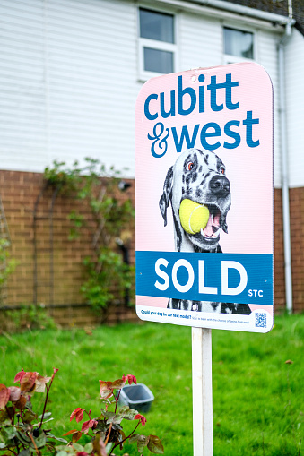 Leatherhead Surrey, UK, March 29 2024, Cubitt and West Estate Agents Sold House Sign Board With No People