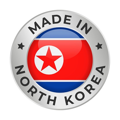 Made in North Korea - Vector Graphics. Round Silver Label Badge Emblem with Flag of North Korea and Text Made in North Korea. Isolated on White Background