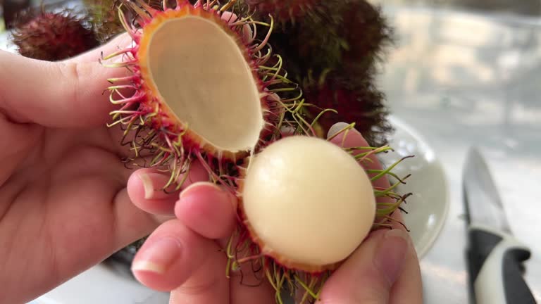 Fresh rambutan with green leaf on wooden background, relating view